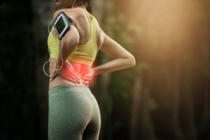 Cropped shot of a young woman experiencing lower back pain