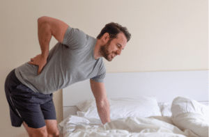 Man waking up in the morning and suffer for back pain