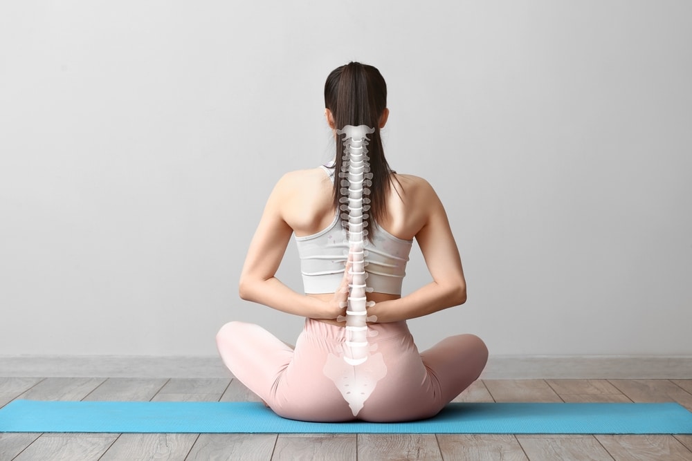 Young,Woman,Practicing,Yoga,In,Gym.,Concept,Of,Healthy,Spine
