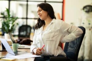 Portrait,Of,Tired,Businesswoman.,Young,Woman,Having,Back,Pain.