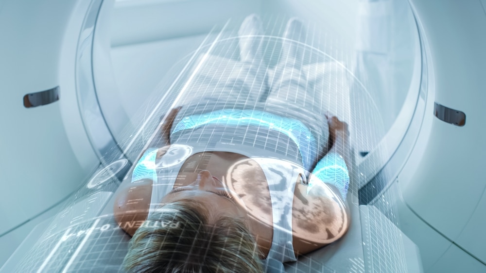 Woman gets a cat or MRI scan to check on spinal issues. Woman gets a cat or MRI scan to check on spinal issues.